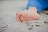Kinderfuß im Sand